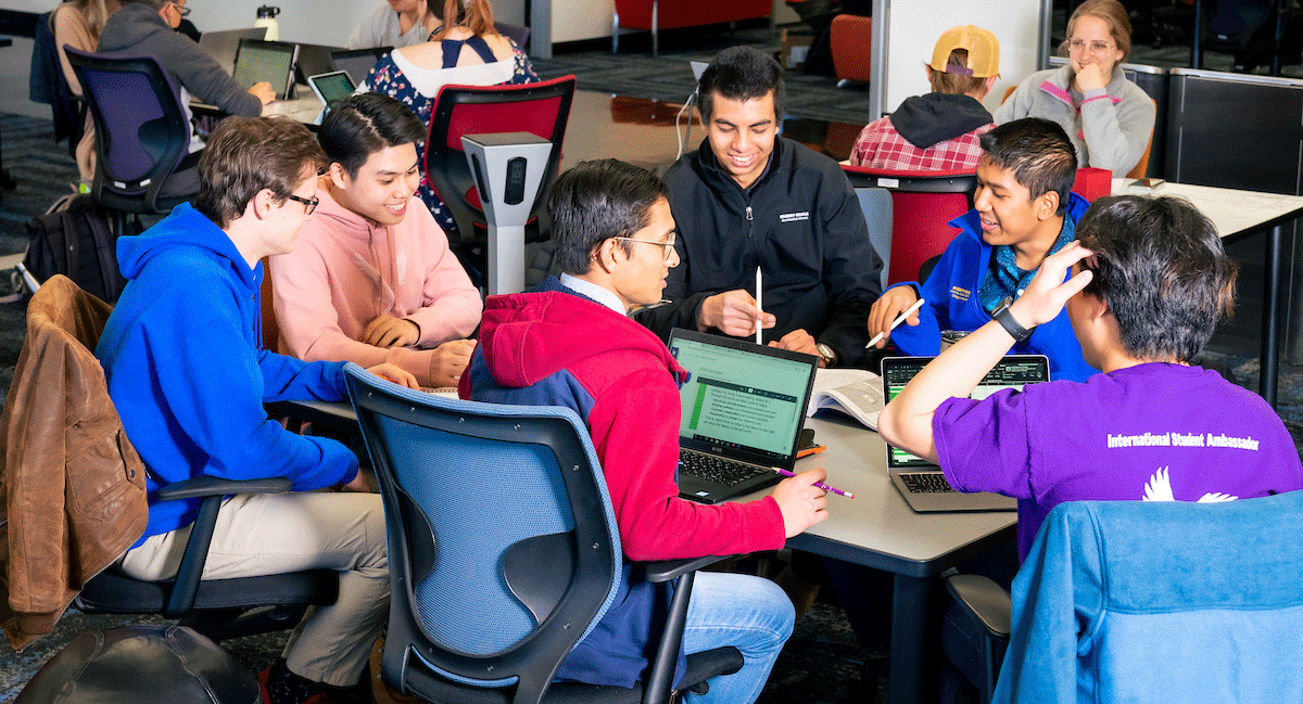 International students sit at a desk