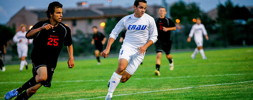 two students play soccer