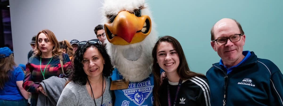 A student and their parents meeting Ernie the Eagle