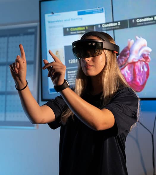 Embry-Riddle Student Jessyca Derby demonstrates the Microsoft Hololens Augmented/Mixed Reality glasses in the Human Factors User Experience Lab