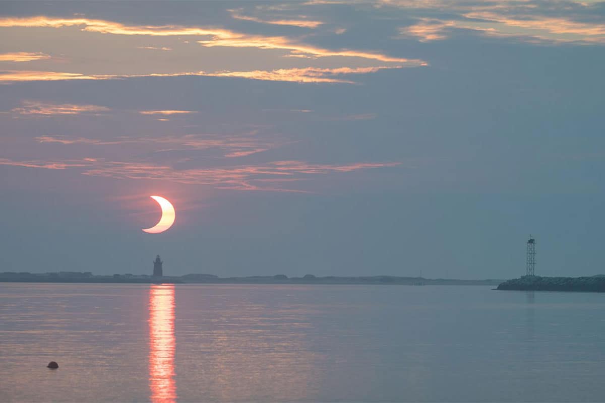 Image of a lunar eclipse over the water