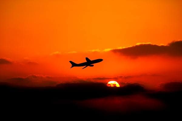 Plane in the sky with sunset
