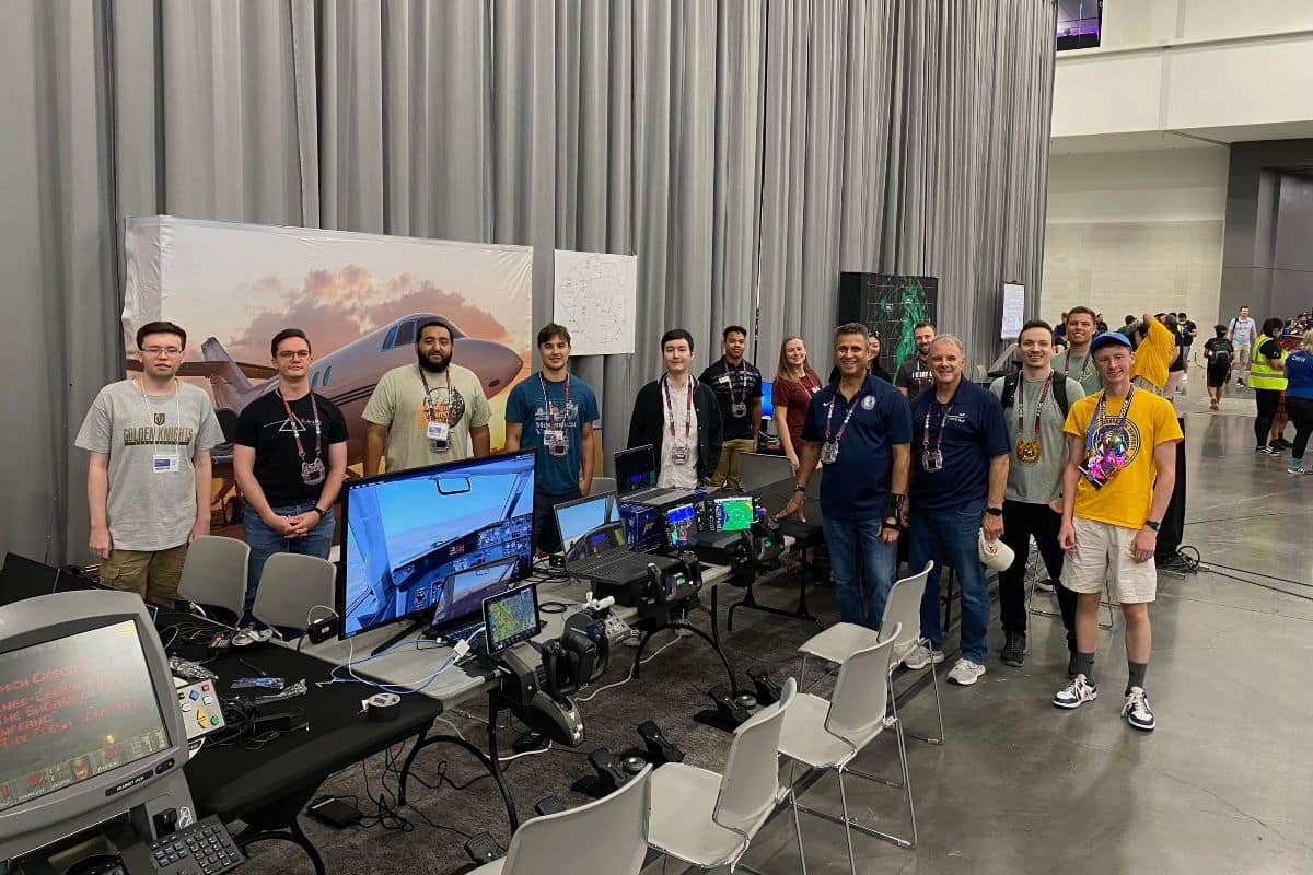 From left to right: Students Nicholas Harris, Michael Boehm, Bernard Correa, Enzo Gonzalez, Trevor French, Christian Hardy and Carol Martin. Standing alongside Martin is Dr. Krishna Sampigethaya, department chair of Cyber Intelligence and Security; student Jennifer Hong; Kyle Wilkerson, assistant professor of Air Traffic Management; Jeffrey Troy, president and CEO of Aviation ISAC; Matt Crandell, IT Administrator at Aviation ISAC; and students Joshua Sawyer and Nathan Johnson. 