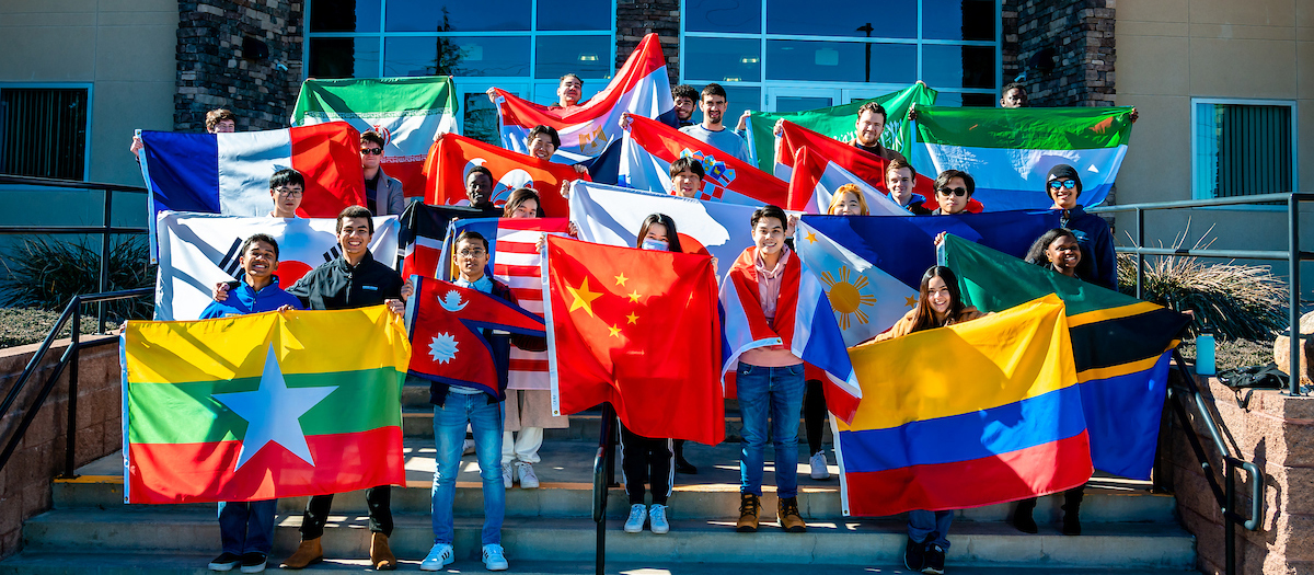 Students hold up international flags