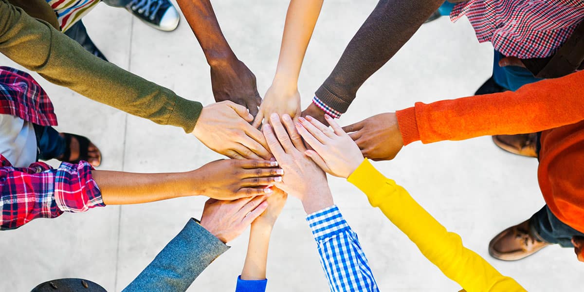 Group of Diverse, Multiethnic People with Their Hands in the Middle