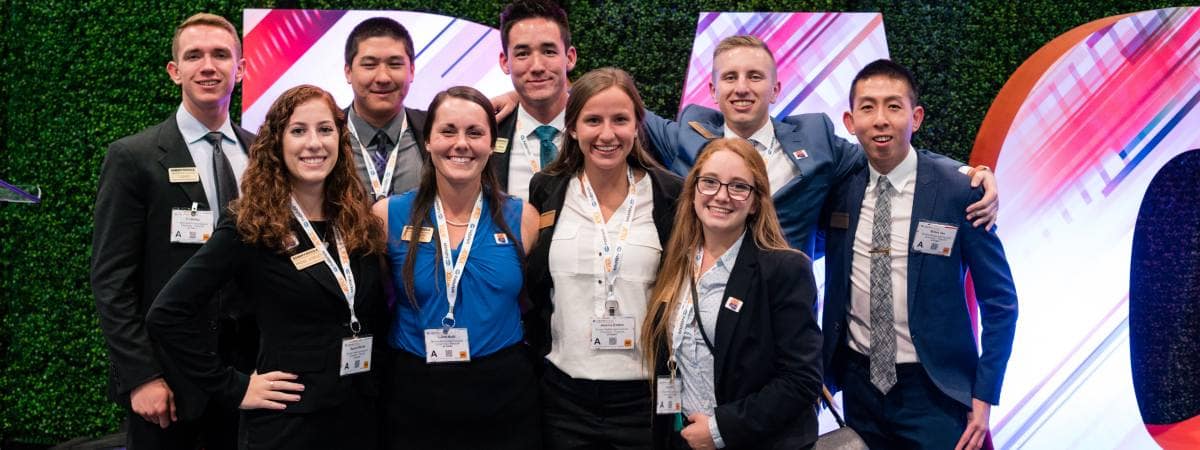 Students line up for a group photo at a conference