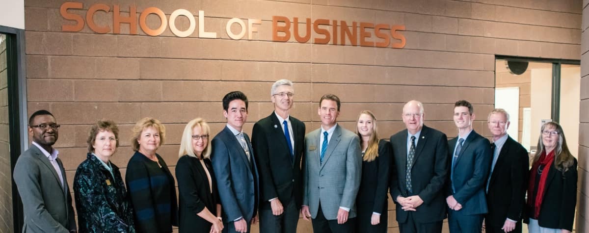 School of Business faculty and staff stand alongside the founder of the School of Business, Robin Sobotta; the Dean of the College of Arts and Sciences, Kathleen Lustyk; Embry-Riddle Aeronautical University President P. Barry Butler; Interim Chair of the School of Business Thomas Drape; and Chancellor of the Prescott Campus Frank Ayers