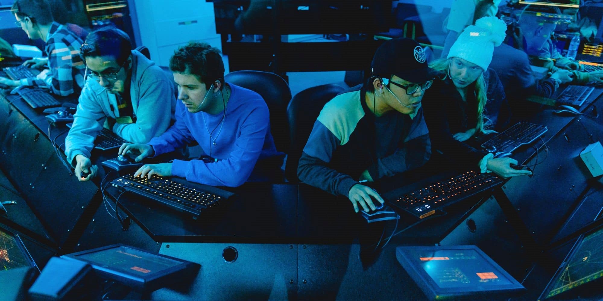 Four students work in the air traffic control center.