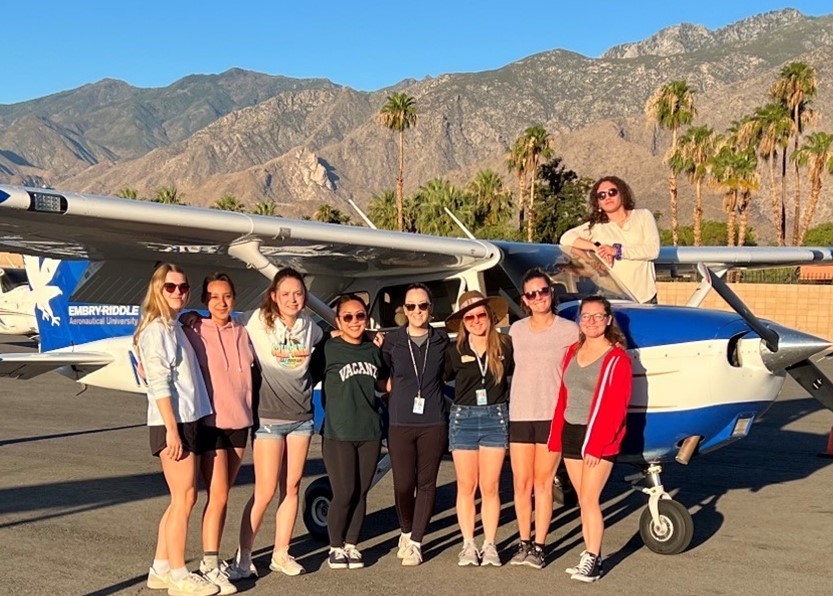 Female students by a plane