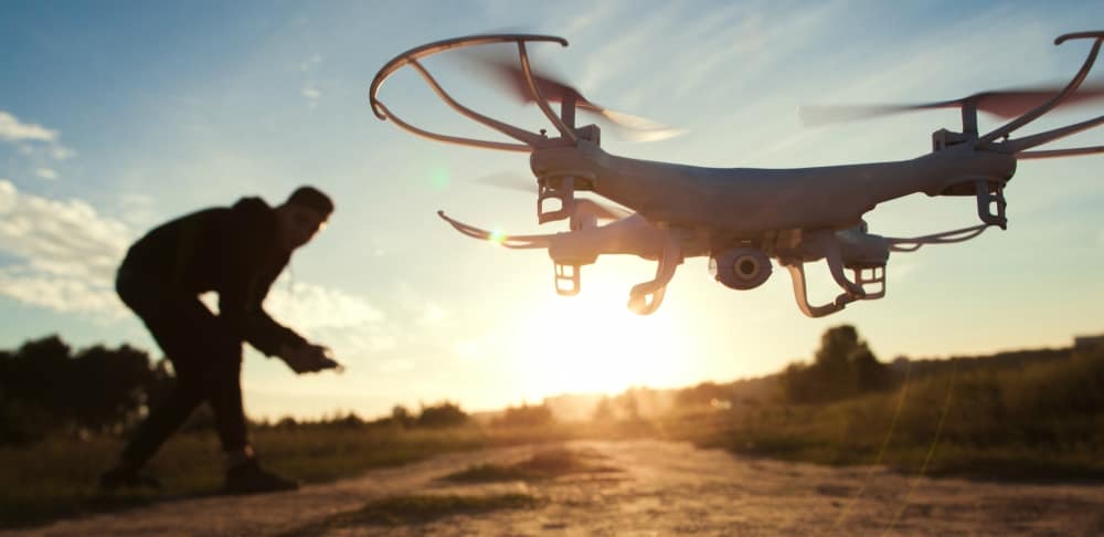 Man flies sUAS by sunset