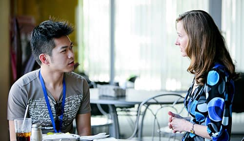 An admissions counselor provides advice and guidance to a student