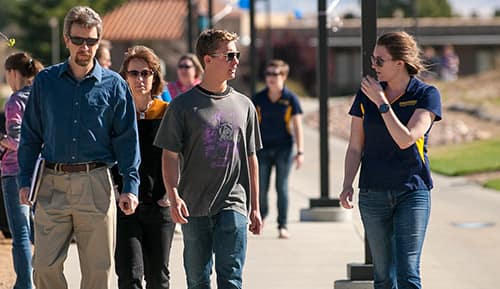 A student leads a prospective student and their family on a tour around Embry-Riddle Aeronautical University's Prescott Campus