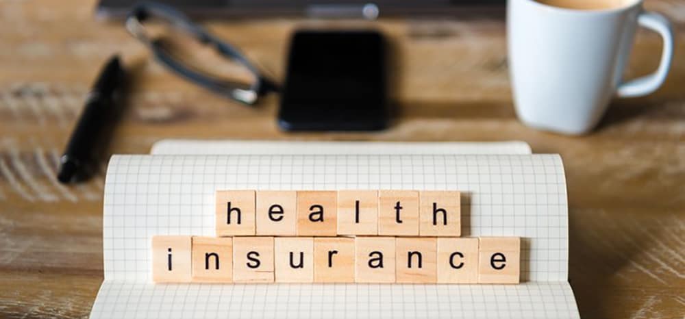 health insurance spelled out in scrabble tiles