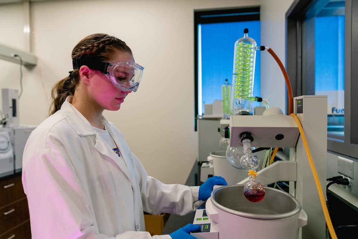 A student operates Chemistry Lab equipment