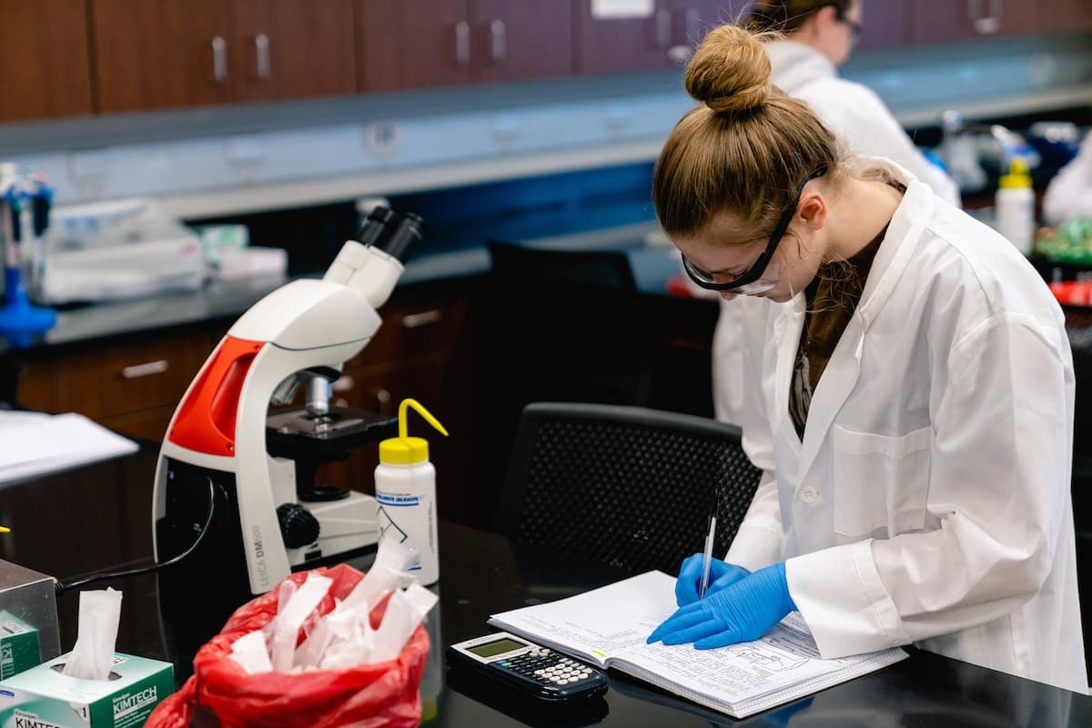 A student documents her results in the Forensic Lab