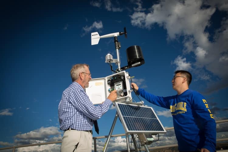 An instructor demonstrates how to operate one of the automated weather observing stations on campus